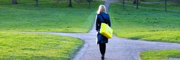 Junge Frau, die einen Weg im Park weg läuft